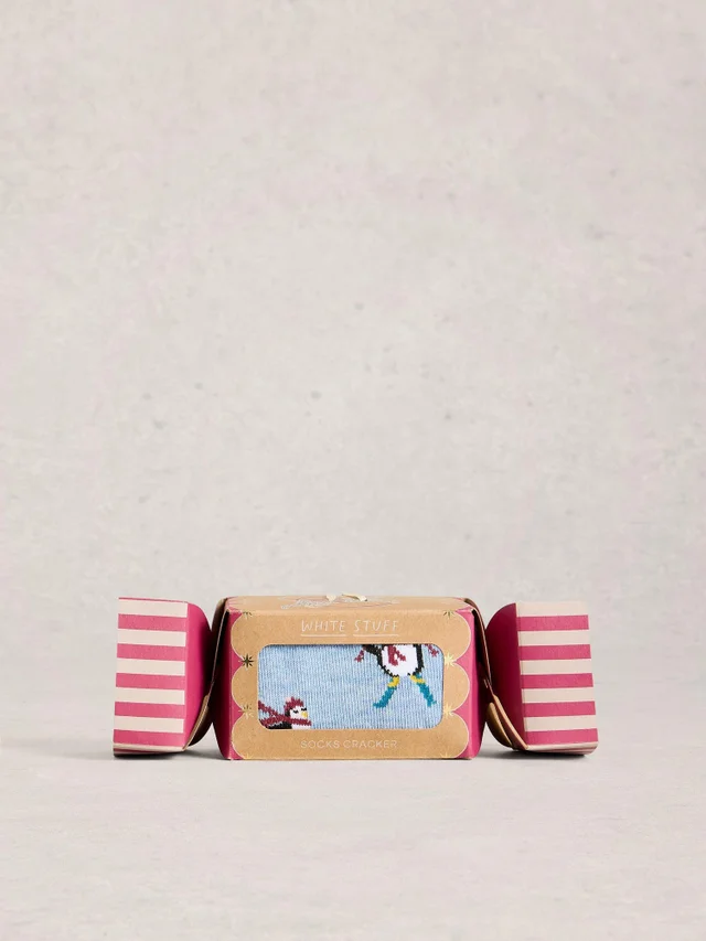 Skilaufende Pinguine im Cracker